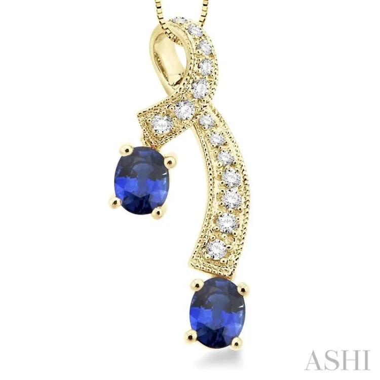 5x4MM Oval Cut Sapphire and 1/6 Ctw Round Cut Diamond Pendant in 14K Yellow Gold with Chain