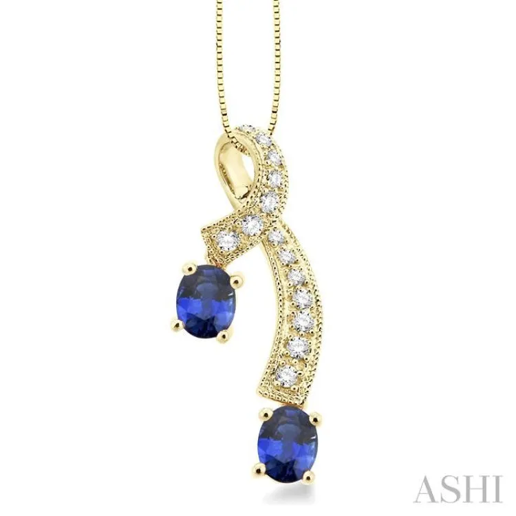 5x4MM Oval Cut Sapphire and 1/6 Ctw Round Cut Diamond Pendant in 14K Yellow Gold with Chain